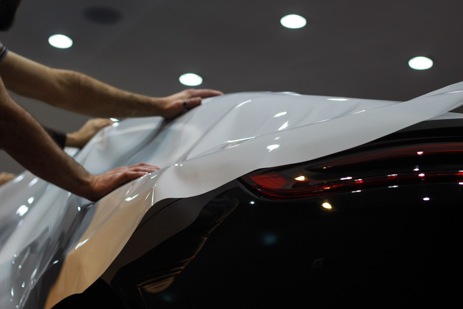Vinyl film being applied to a vehicle during a wrap installation
